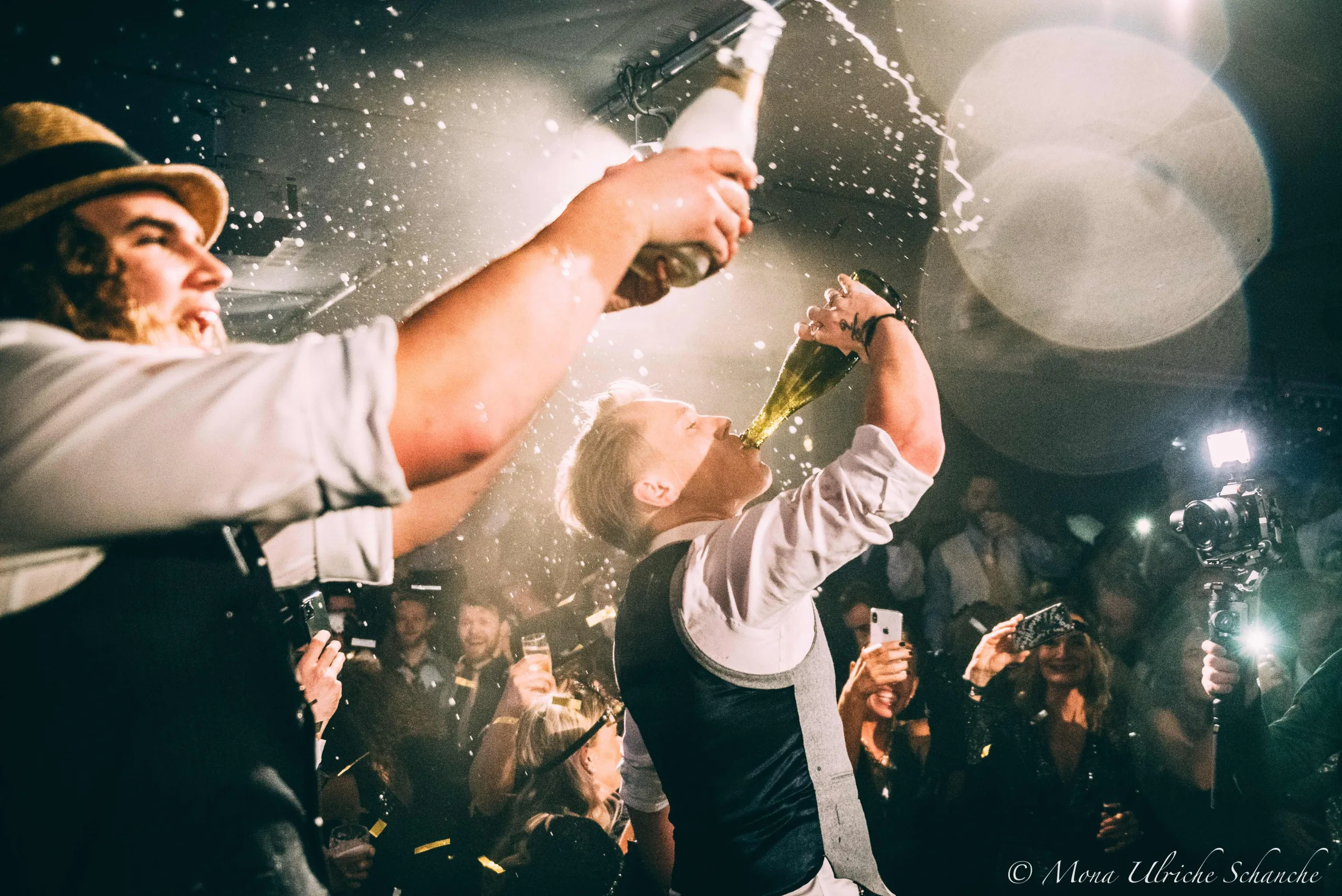 Swing'it performers celebrating with champagne during a concert